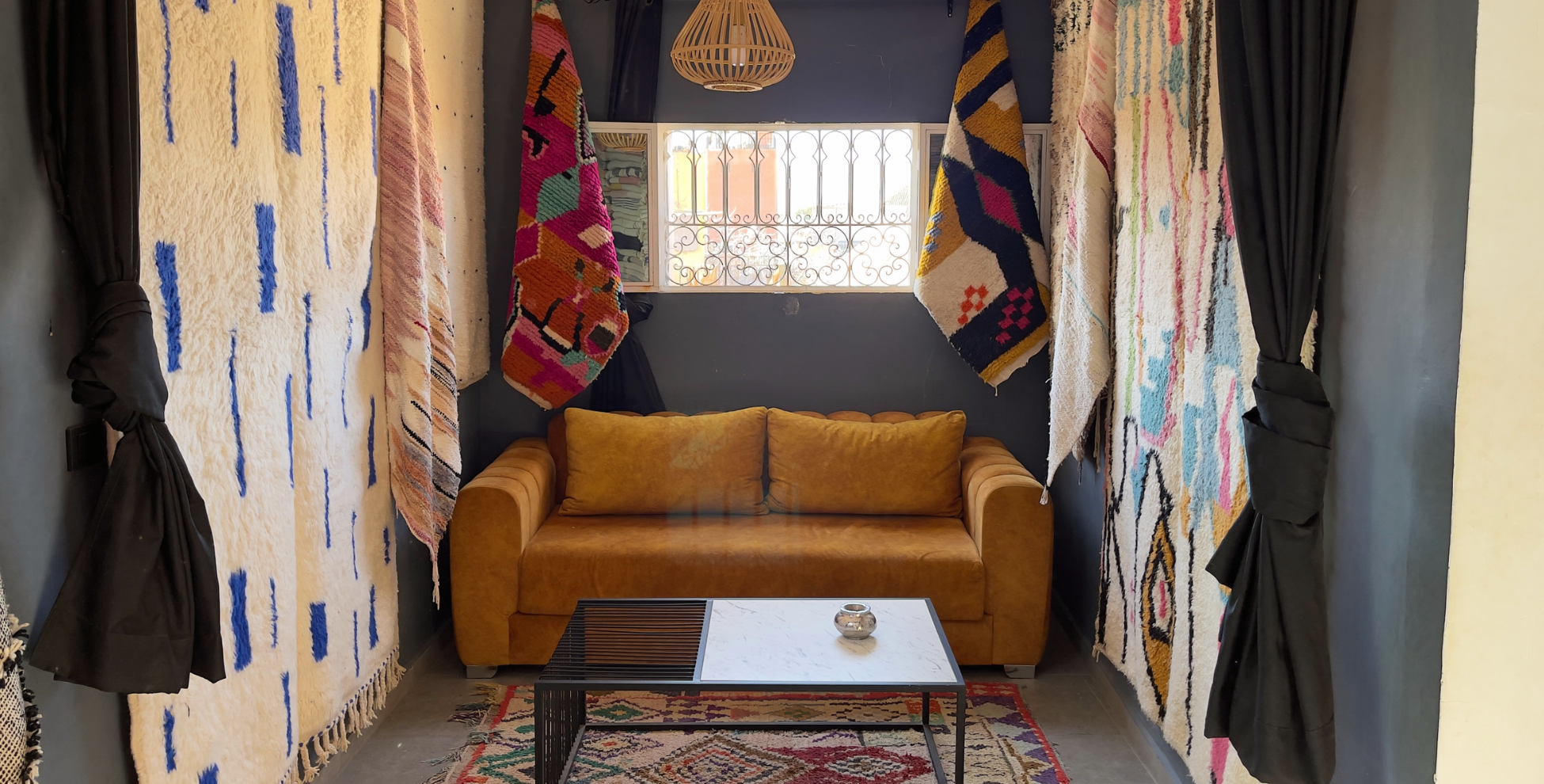 A cozy living room with a custom Moroccan rug as the centerpiece. The rug has intricate patterns and bold colors, adding a unique touch to the space. 